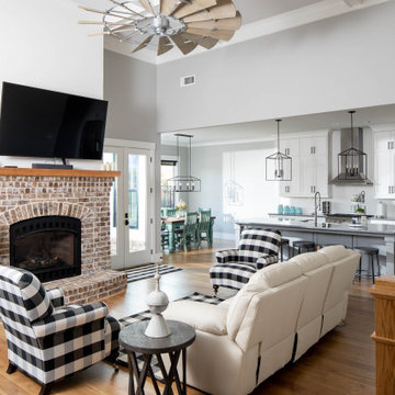 Great Room with Buffalo Check Accents and Oak Staircase