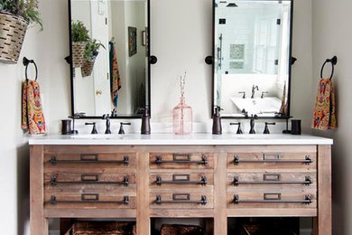 Example of a large arts and crafts master ceramic tile and brown floor bathroom design in Boston with flat-panel cabinets, medium tone wood cabinets, beige walls, an undermount sink, marble countertops and a hinged shower door