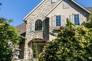 Inspiration for a huge contemporary beige two-story mixed siding exterior home remodel in Other with a shingle roof