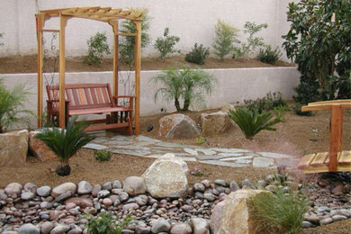 This is an example of a mid-sized traditional drought-tolerant and full sun backyard stone garden path in Las Vegas for summer.