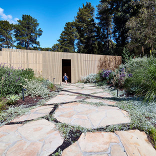 Design ideas for a large contemporary full sun garden in Melbourne with a garden path and natural stone pavers.