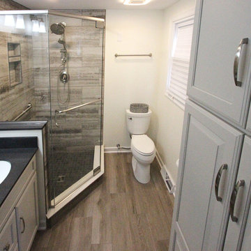 Gray Master Bathroom with Tiled Shower and Barn Door
