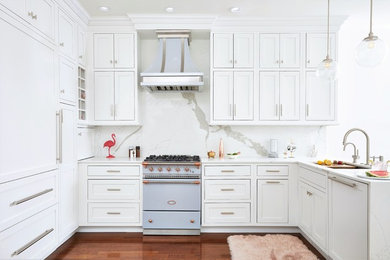 Mid-sized transitional u-shaped open plan kitchen in Philadelphia with a single-bowl sink, beaded inset cabinets, white cabinets, marble benchtops, white splashback, marble splashback, panelled appliances, medium hardwood floors, no island, beige floor and white benchtop.
