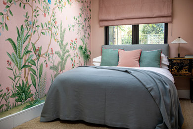 Small elegant guest carpeted, beige floor and wallpaper bedroom photo in London with pink walls