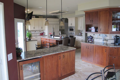 Inspiration for a large transitional u-shaped ceramic tile and beige floor eat-in kitchen remodel in Seattle with an undermount sink, shaker cabinets, beige cabinets, granite countertops, beige backsplash, ceramic backsplash, paneled appliances and an island