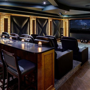 Cette image montre une grande salle de cinéma traditionnelle ouverte avec un mur bleu, un sol en carrelage de porcelaine, un écran de projection et un sol marron.