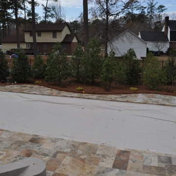 Fiberglass Swimming Pool with Travertine Decking and Automatic Cover