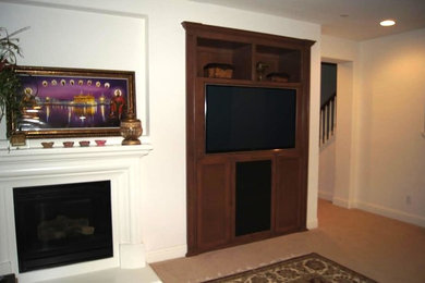 Example of a mid-sized classic enclosed carpeted living room library design in Sacramento with white walls, a standard fireplace, a plaster fireplace and a media wall
