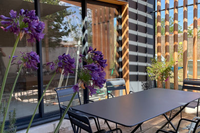 Design ideas for a medium sized contemporary patio in Nantes with a pergola.