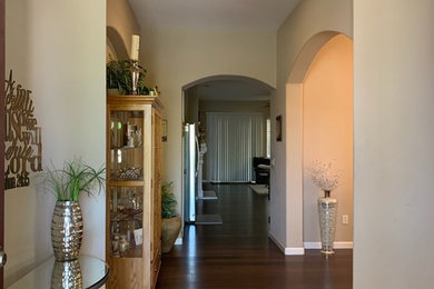 Inspiration for a mid-sized timeless dark wood floor and brown floor hallway remodel in Sacramento with gray walls