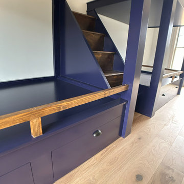 Spacious Shared Kids Room with Custom Bunk Beds, Integrated Drawers, and Vaulted