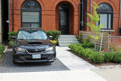 Design ideas for a mid-sized eclectic full sun front yard concrete paver landscaping in Toronto for summer.