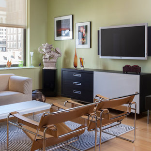 This is an example of a medium sized contemporary open plan home cinema in Philadelphia with green walls, bamboo flooring and a wall mounted tv.