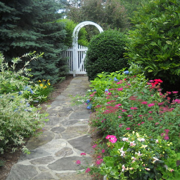 A stone path leads to the arbor