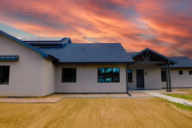 Large trendy gray two-story stucco exterior home photo in Denver with a shingle roof and a gray roof