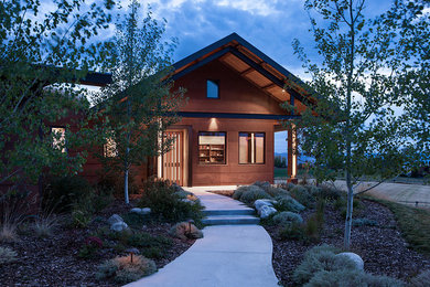 Example of a mid-sized minimalist brown two-story metal exterior home design in Other with a metal roof
