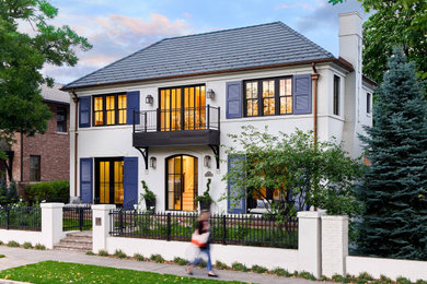 Example of a transitional white two-story brick house exterior design in Denver with a black roof