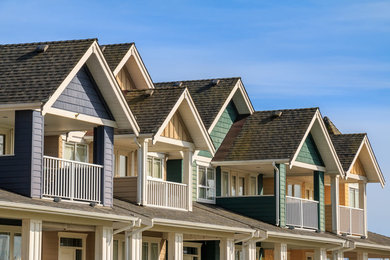 Inspiration for a large contemporary multicolored three-story townhouse exterior remodel in Minneapolis with a shingle roof