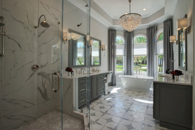 シャーロットにあるモダンスタイルのおしゃれな浴室 (グレーのキャビネット、セラミックタイルの床、白い洗面カウンター、洗面台2つ) の写真