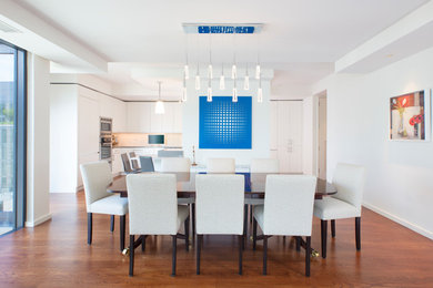 This is an example of a mid-sized contemporary open plan dining in DC Metro with white walls, light hardwood floors, brown floor and no fireplace.