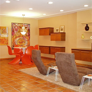 Large modern walk-out basement in Philadelphia with yellow walls and terracotta flooring.