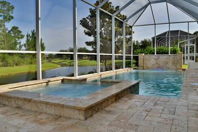 Photo of a small modern backyard rectangular pool in Orlando with a water feature.