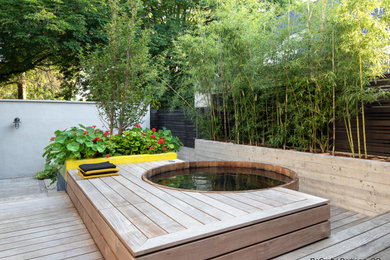 Design ideas for a mid-sized contemporary backyard deck in Portland with with privacy feature and no cover.