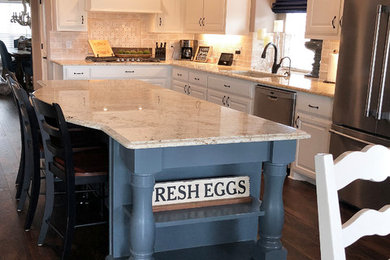Inspiration for a large transitional l-shaped dark wood floor and brown floor eat-in kitchen remodel in Dallas with an undermount sink, raised-panel cabinets, white cabinets, granite countertops, beige backsplash, travertine backsplash, stainless steel appliances, an island and beige countertops