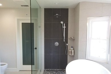 Mid-sized transitional master beige tile and porcelain tile porcelain tile and beige floor bathroom photo in Los Angeles with furniture-like cabinets, medium tone wood cabinets, beige walls, an undermount sink, quartz countertops and gray countertops