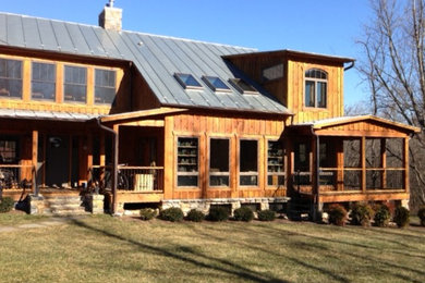 Inspiration for a huge rustic brown two-story wood exterior home remodel in Other
