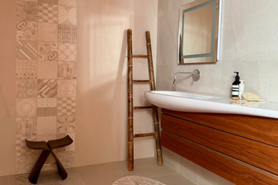 Inspiration for a medium sized modern shower room bathroom in Hertfordshire with flat-panel cabinets, medium wood cabinets, a walk-in shower, a wall mounted toilet, beige tiles, beige walls, porcelain flooring, a trough sink, beige floors, an open shower, a wall niche, a single sink and a floating vanity unit.
