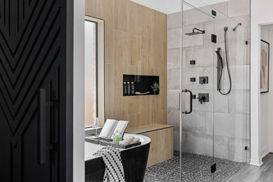 Example of a trendy beige tile and gray tile pebble tile floor and gray floor bathroom design in Dallas with white walls, a hinged shower door and a niche