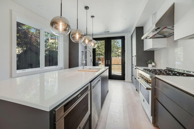 Mid-sized transitional galley open concept kitchen photo in DC Metro with an undermount sink, flat-panel cabinets, gray cabinets, quartz countertops, white backsplash, quartz backsplash, stainless steel appliances, an island and white countertops