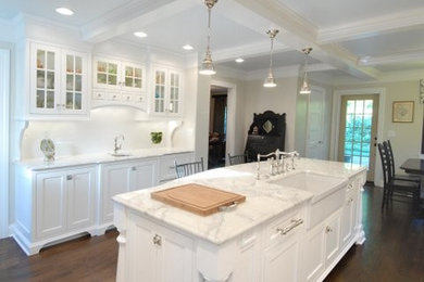 Inspiration for a mid-sized timeless u-shaped dark wood floor and brown floor eat-in kitchen remodel in Other with a farmhouse sink, shaker cabinets, white cabinets, marble countertops, white backsplash, porcelain backsplash and no island