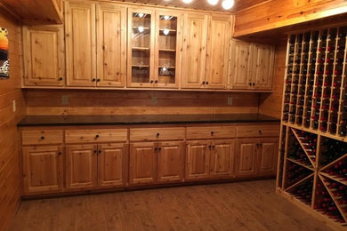 Inspiration for a large timeless medium tone wood floor wine cellar remodel in Other