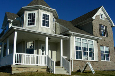 Example of a large classic two-story house exterior design in Chicago