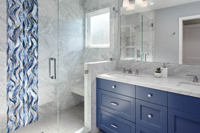 Alcove shower - mid-sized transitional master gray tile and marble tile porcelain tile and gray floor alcove shower idea in San Francisco with shaker cabinets, blue cabinets, a two-piece toilet, gray walls, an undermount sink, marble countertops, a hinged shower door and gray countertops