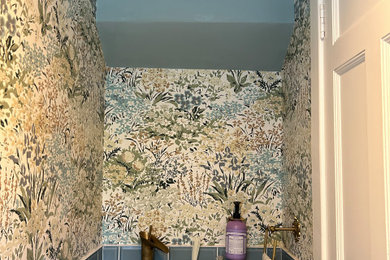 Example of a small eclectic blue tile and ceramic tile terra-cotta tile, orange floor, single-sink and wallpaper bathroom design in Dublin with a one-piece toilet, multicolored walls, a vessel sink, wood countertops, a niche and a floating vanity