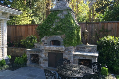 Inspiration for a large timeless backyard stamped concrete patio remodel in Other with no cover