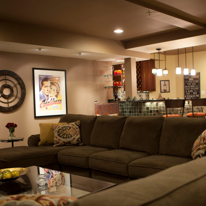 Large transitional underground carpeted basement photo in Philadelphia with beige walls and no fireplace