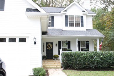 Example of a mid-sized transitional white two-story vinyl and board and batten exterior home design in Charlotte with a shingle roof and a gray roof
