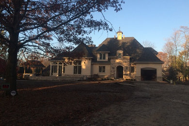 Example of a huge classic beige two-story mixed siding exterior home design in Indianapolis with a tile roof