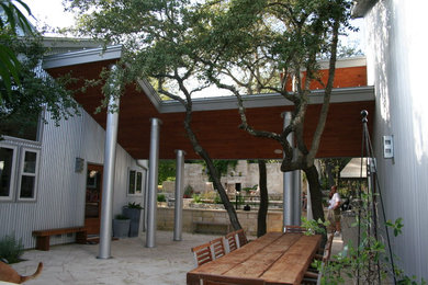 Inspiration for a modern gray two-story metal apartment exterior remodel in Austin with a shed roof, a metal roof and a gray roof