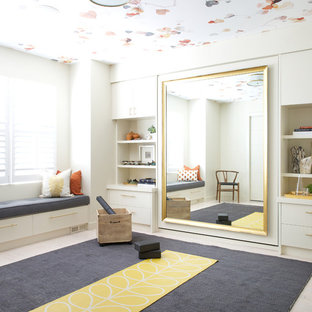 This is an example of a classic home yoga studio in Calgary with beige walls and beige floors.