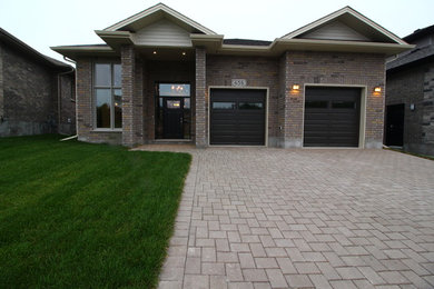 Inspiration for a large contemporary multicolored one-story exterior home remodel in Toronto with a hip roof