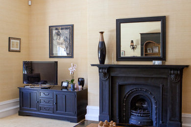 Victorian living room in Other with a stone fireplace surround.