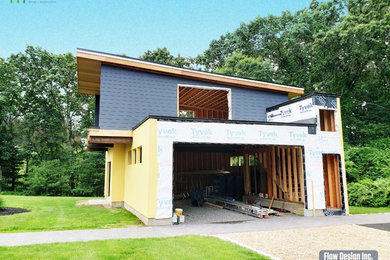 Garage workshop - mid-sized modern detached two-car garage workshop idea in Boston