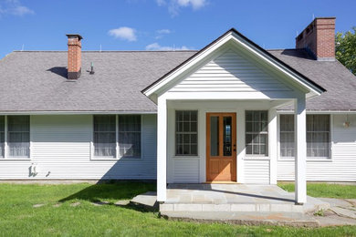 Traditional wood exterior home idea in Burlington with a shingle roof