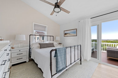Small beach style guest vinyl floor bedroom photo in Other with gray walls