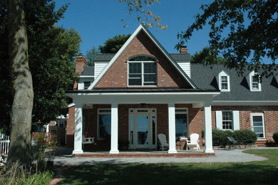 Mid-sized traditional brown two-story brick exterior home idea in DC Metro with a shingle roof